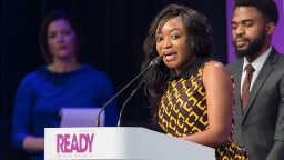 Ndifanji giving a speech at the lectern at the Malaria Summit London 2018