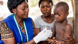 Health worker treating a child