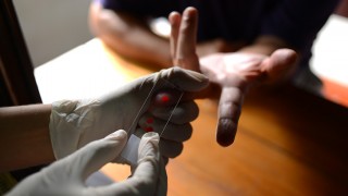 A finger of someone receiving a malaria test